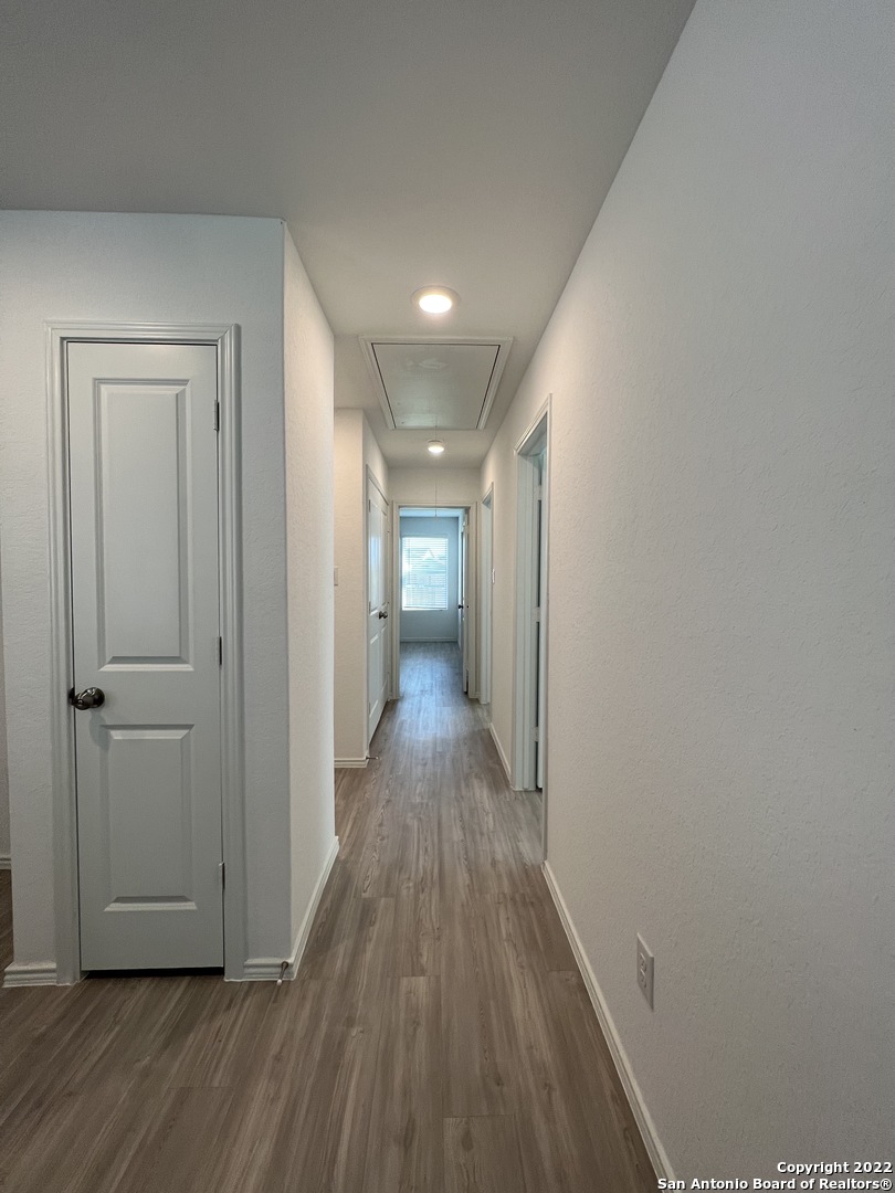7314 Silos Ridge San Antonio, TX 78252 - Photo 17 of 45 a view of a hallway with wooden floor