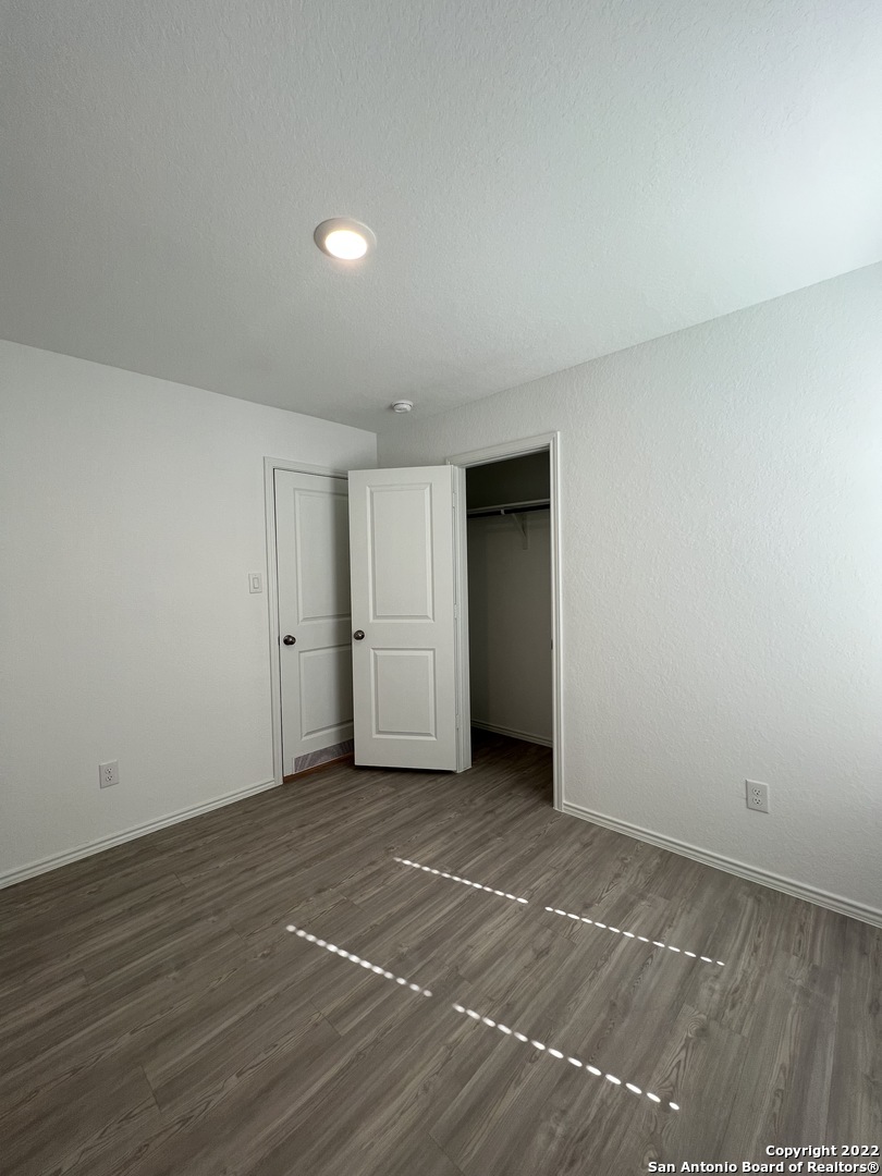 7314 Silos Ridge San Antonio, TX 78252 - Photo 19 of 45 a view of an empty room with wooden floor and closet