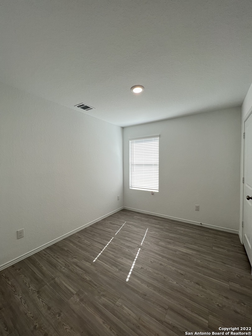 7314 Silos Ridge San Antonio, TX 78252 - Photo 24 of 45 an empty room with wooden floor and windows