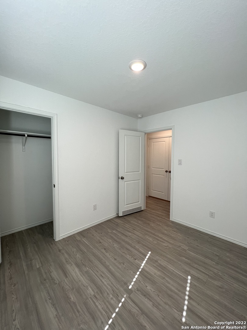 7314 Silos Ridge San Antonio, TX 78252 - Photo 25 of 45 a view of an empty room with wooden floor and closet