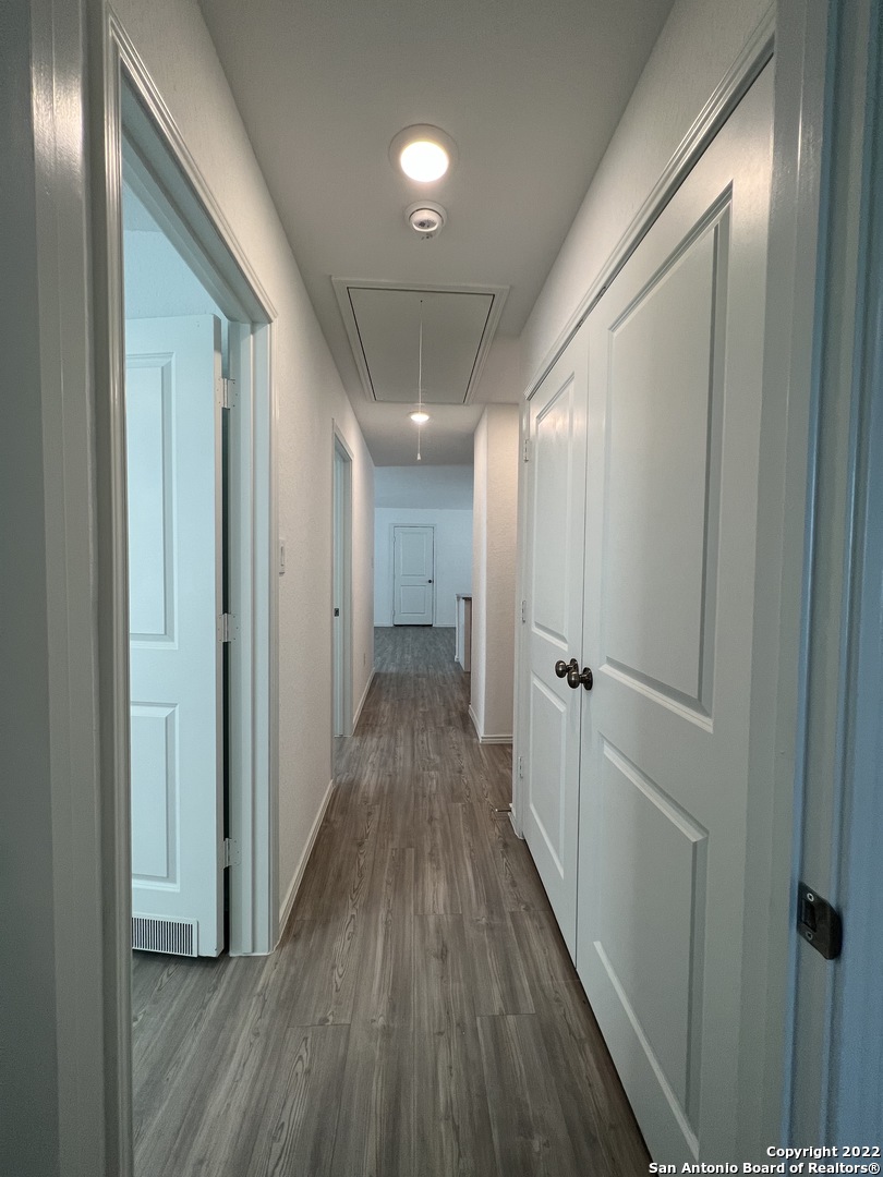7314 Silos Ridge San Antonio, TX 78252 - Photo 27 of 45 a view of a hallway with wooden floor