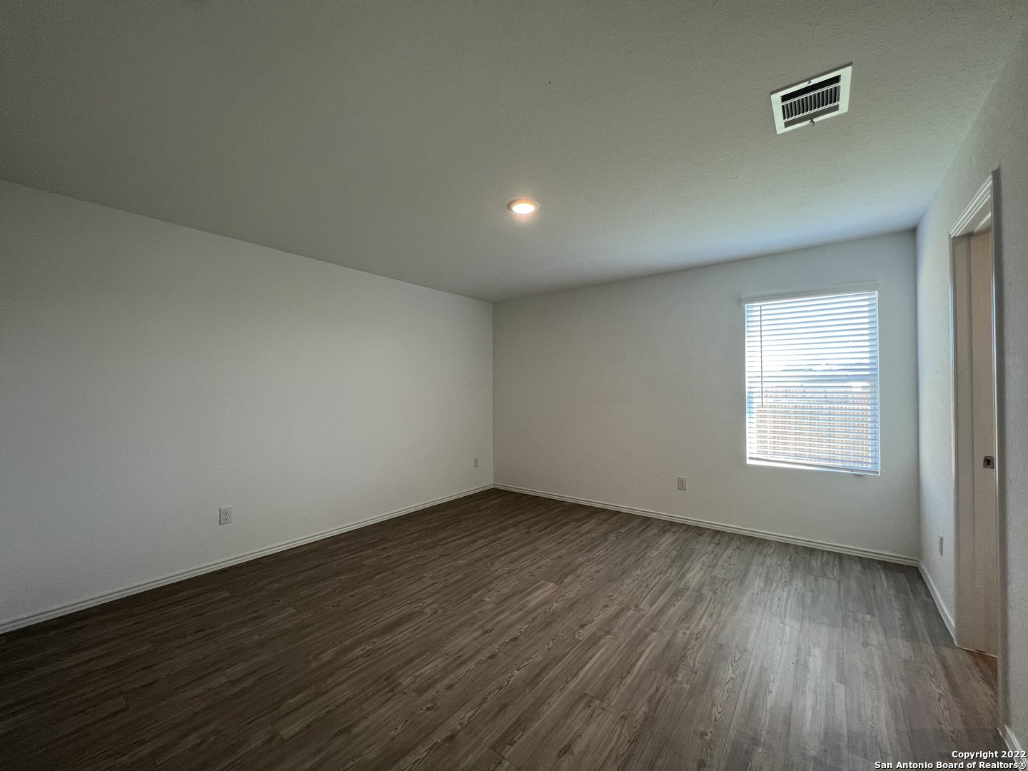 7314 Silos Ridge San Antonio, TX 78252 - Photo 29 of 45 an empty room with wooden floor and windows