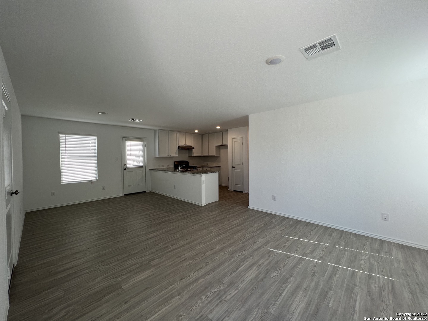7314 Silos Ridge San Antonio, TX 78252 - Photo 4 of 45 a view of a kitchen with a sink cabinets and wooden floor