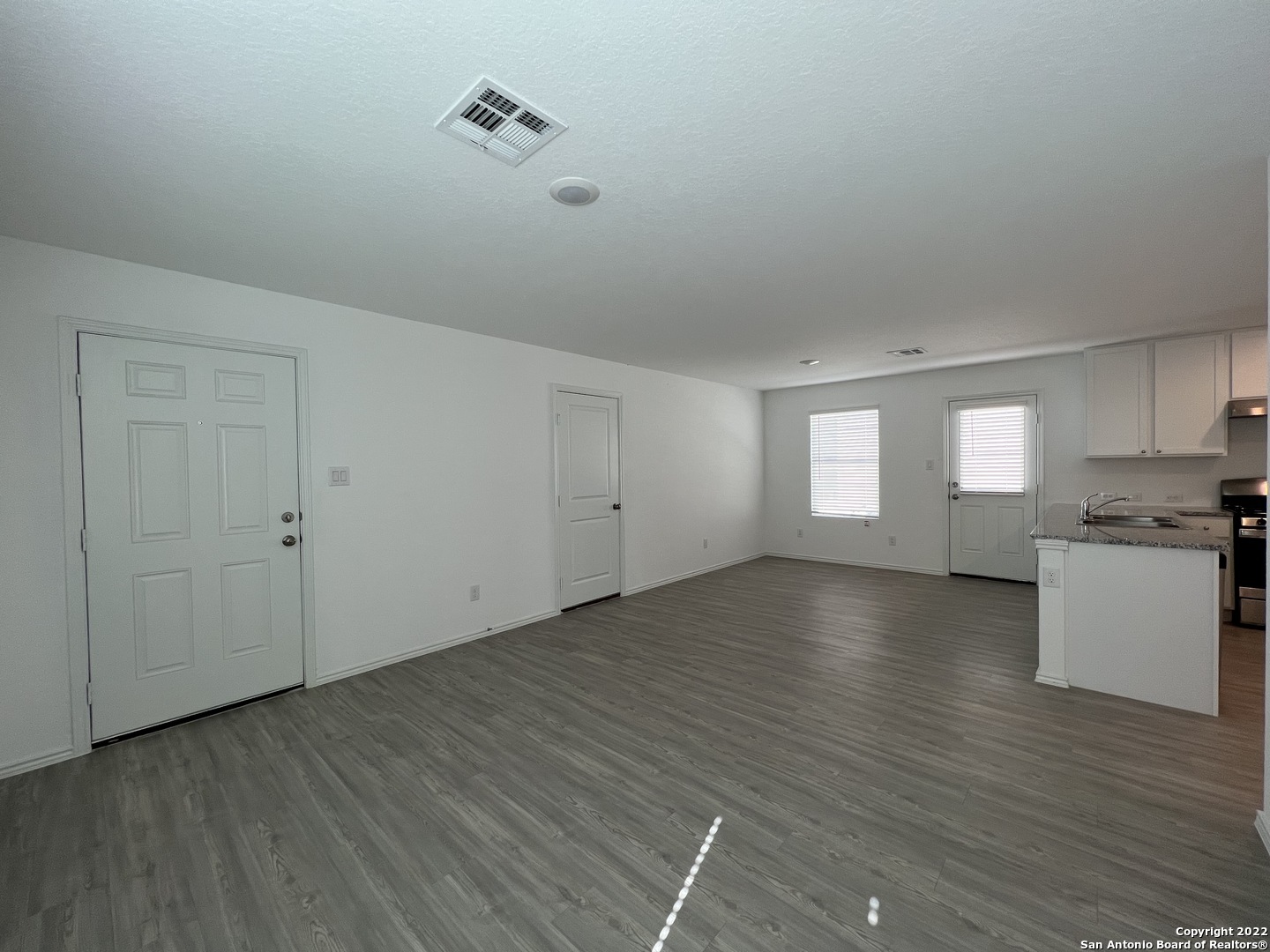7314 Silos Ridge San Antonio, TX 78252 - Photo 5 of 45 an empty room with wooden floor and windows