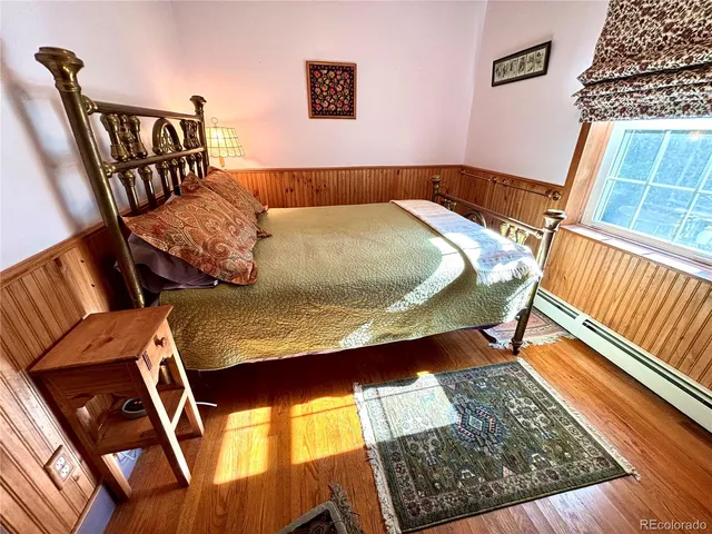 a bed sitting in a bedroom next to a window