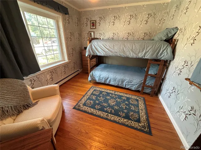 a bedroom with a bed couch and window