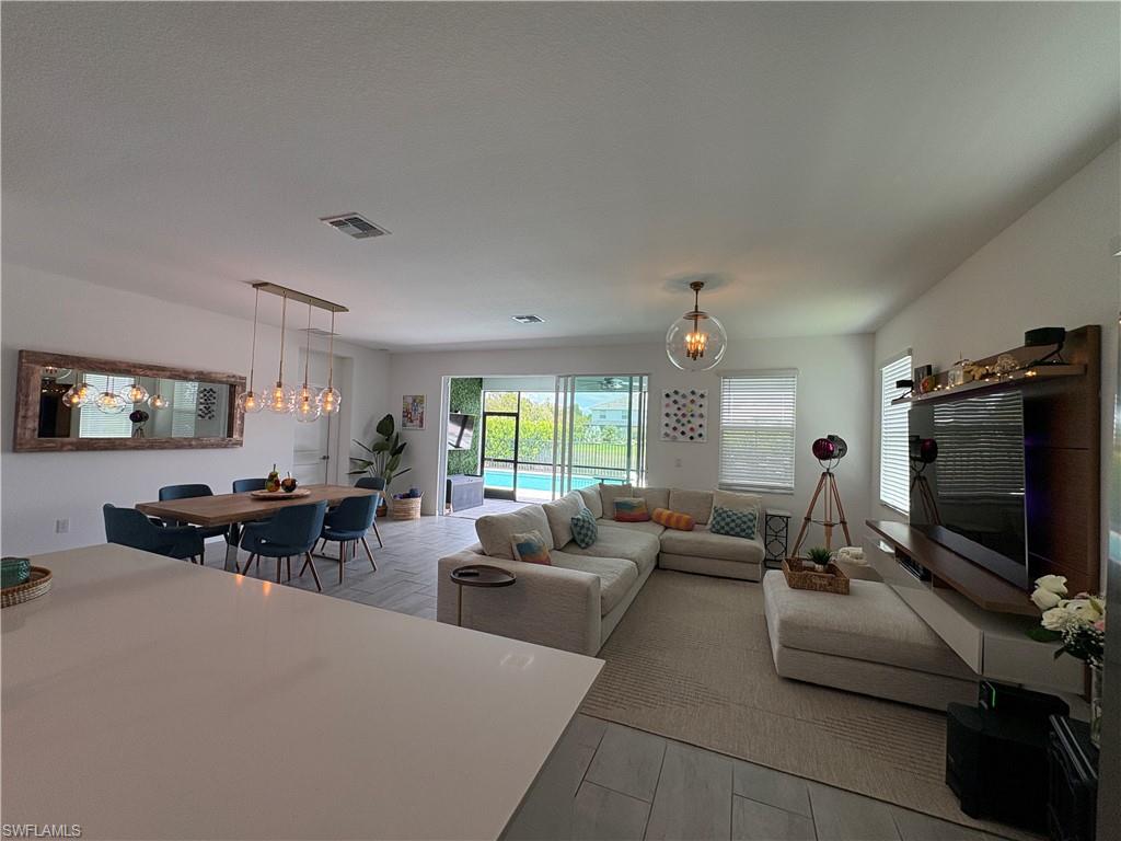 2458 Orchard Street Naples, FL 34120 - Photo 16 of 43 a living room with furniture and a flat screen tv