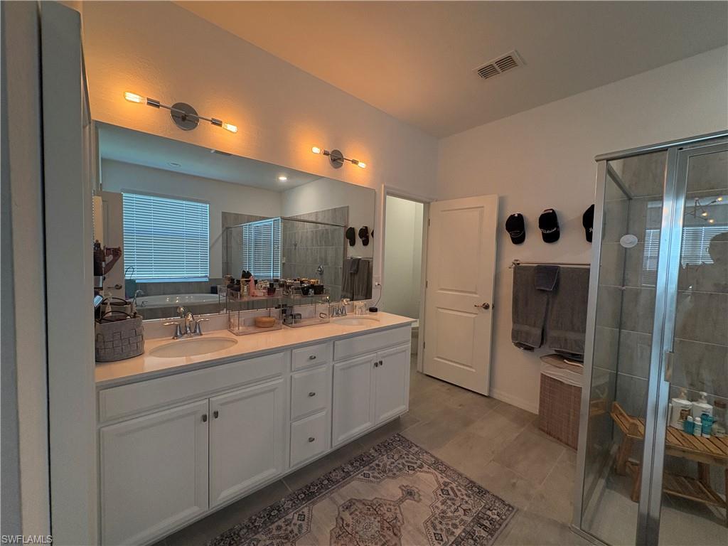 2458 Orchard Street Naples, FL 34120 - Photo 25 of 43 a bathroom with a double vanity sink and mirror