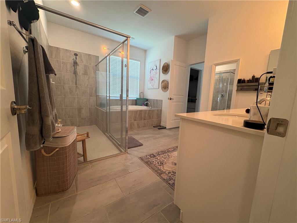 2458 Orchard Street Naples, FL 34120 - Photo 26 of 43 a room with a washing machine and a glass door shower