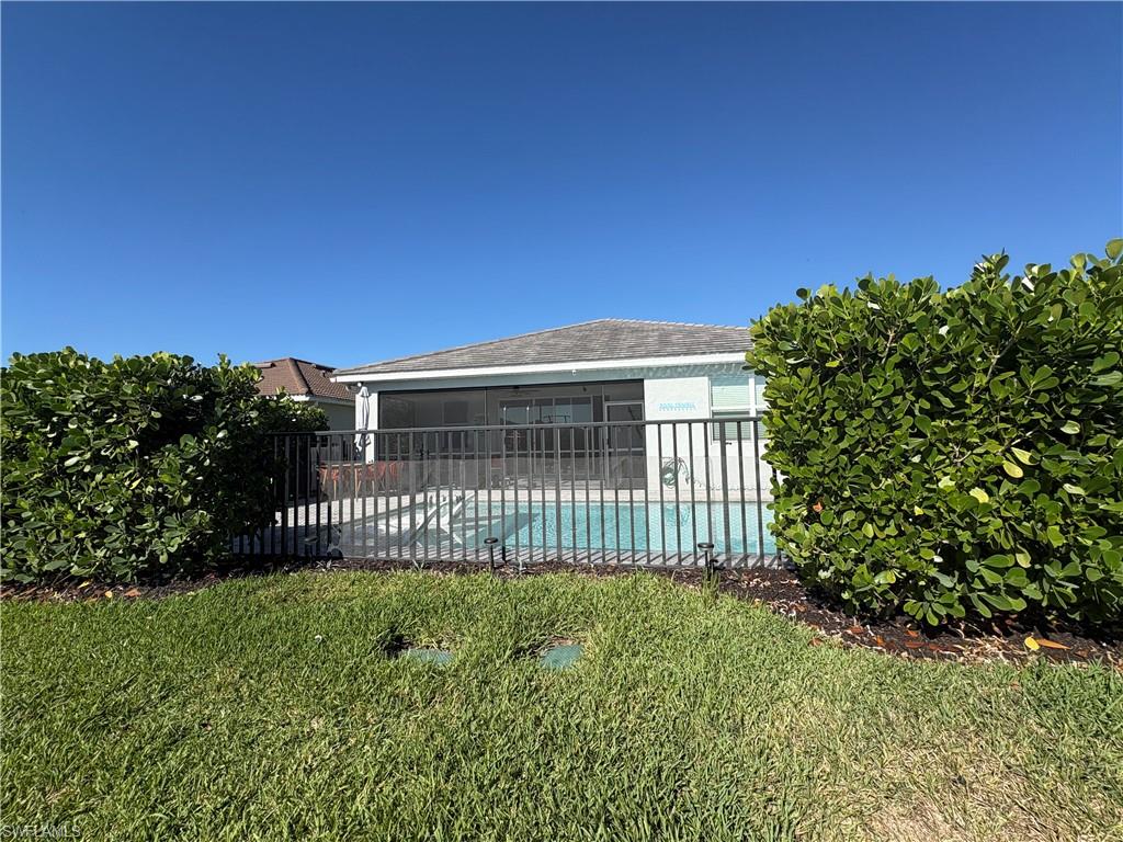 2458 Orchard Street Naples, FL 34120 - Photo 3 of 43 a view of a house with a small yard and a garden