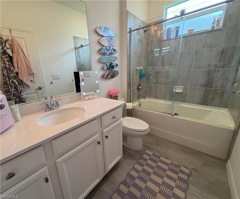2458 Orchard Street Naples, FL 34120 - Photo 34 of 43 a bathroom with a sink a toilet and shower