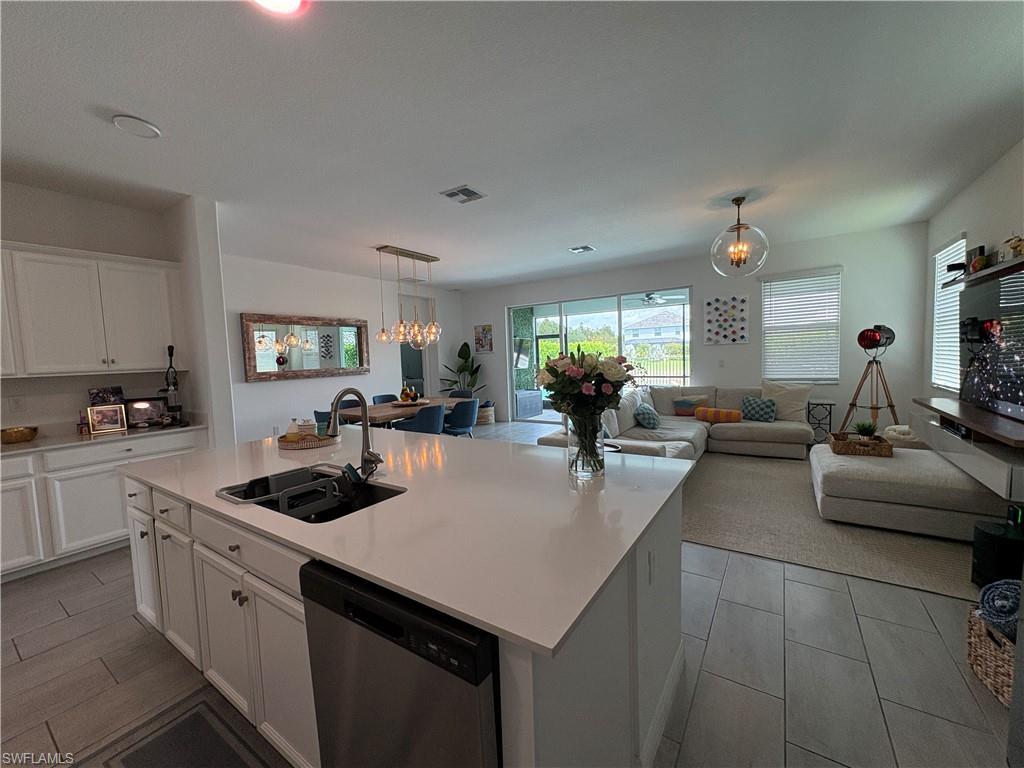 2458 Orchard Street Naples, FL 34120 - Photo 38 of 43 a kitchen with stainless steel appliances granite countertop a sink a stove and cabinets