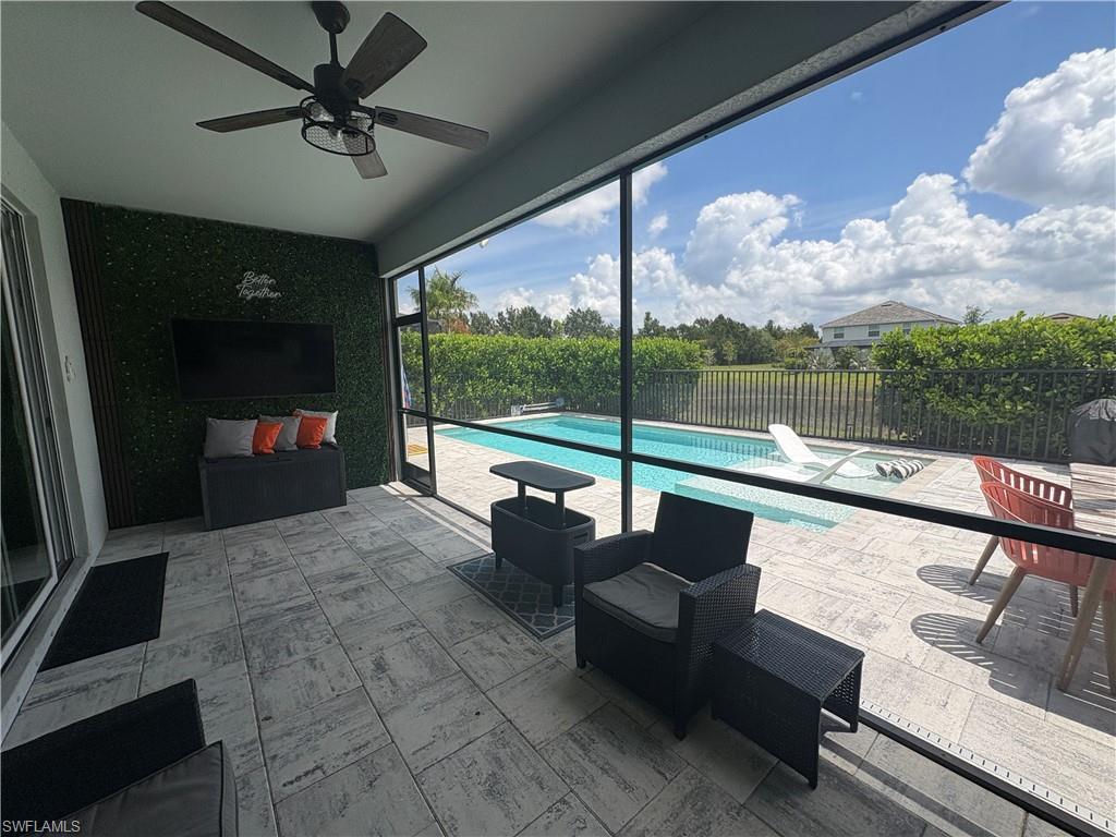 2458 Orchard Street Naples, FL 34120 - Photo 39 of 43 a building outdoor space with patio couch and glass door