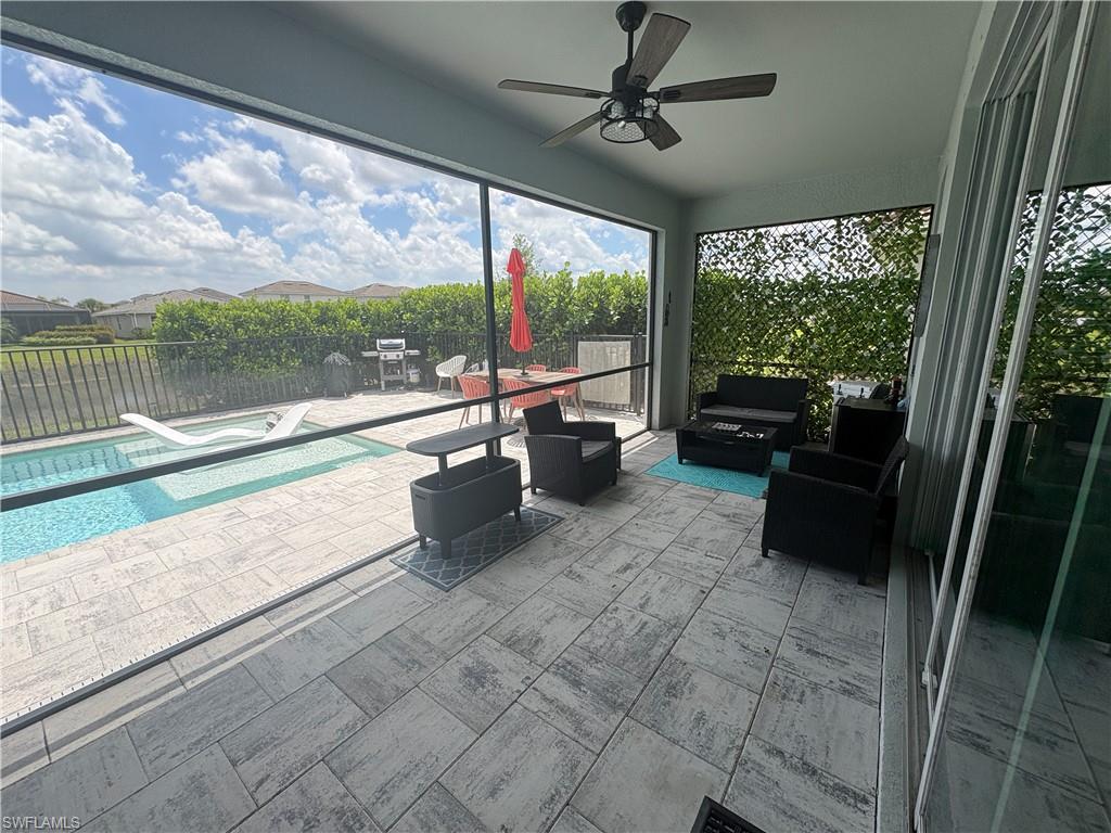 2458 Orchard Street Naples, FL 34120 - Photo 40 of 43 a building outdoor space with patio furniture and a large window