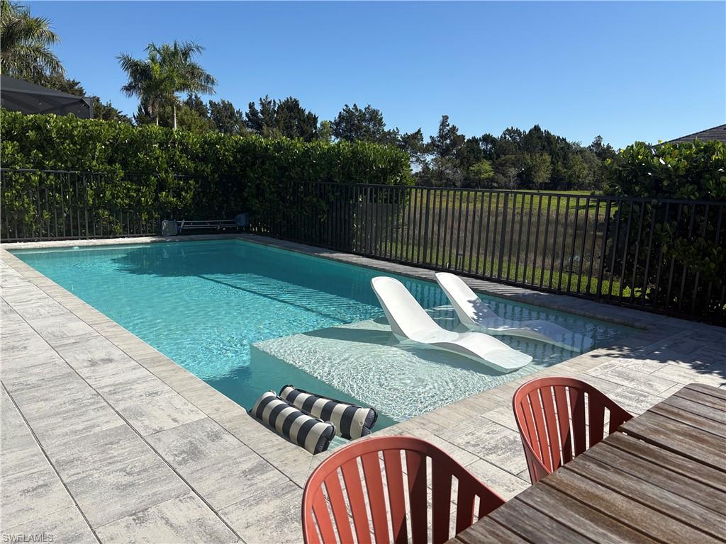 2458 Orchard Street Naples, FL 34120 - Photo 4 of 43 a view of balcony with wooden floor and outdoor seating