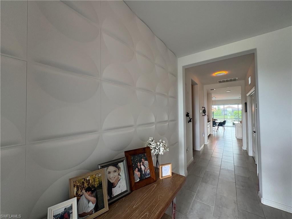 2458 Orchard Street Naples, FL 34120 - Photo 7 of 43 a view of a hallway with wooden floor