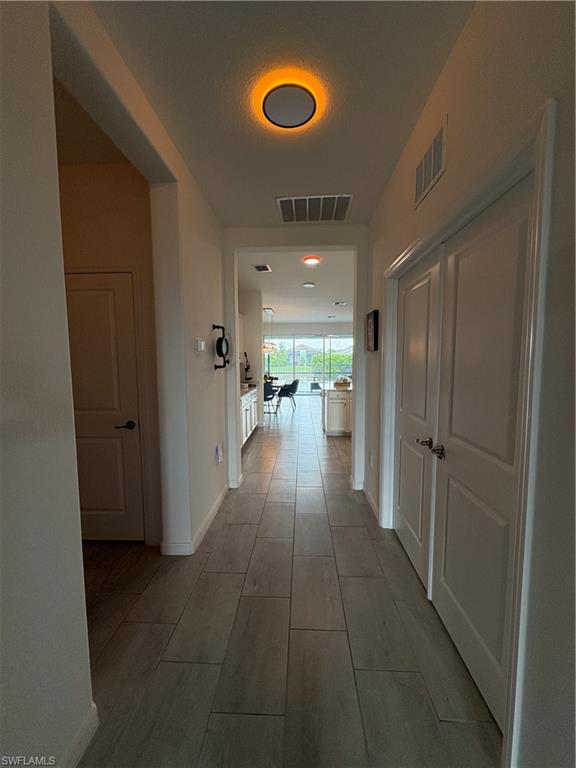 2458 Orchard Street Naples, FL 34120 - Photo 9 of 43 a hallway with mirror