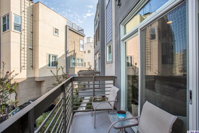 a view of balcony with couple of chairs