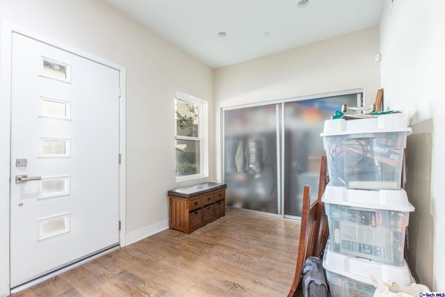 a kitchen with white cabinets and refrigerator
