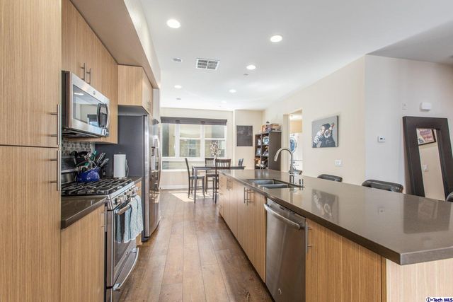 a kitchen with lots of counter top space and stainless steel appliances