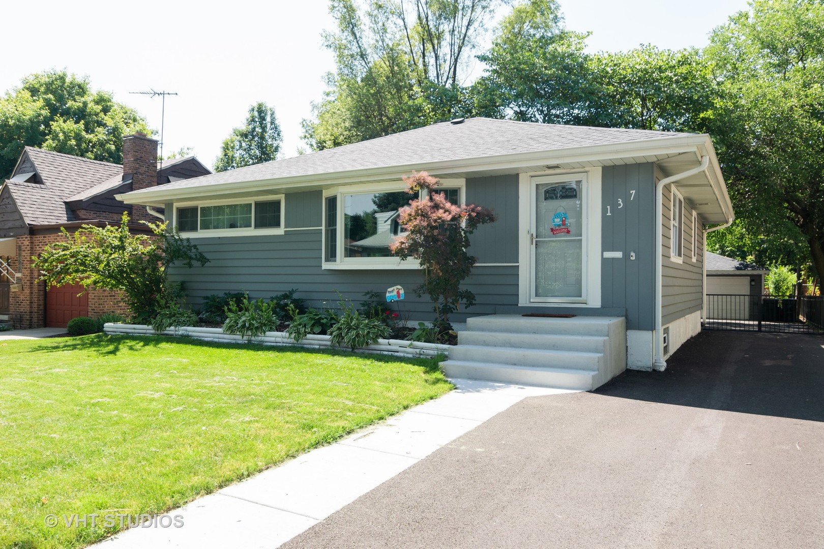 137 East Quincy Street Riverside, IL 60546 - Photo 1 of 14 a front view of a house with garden