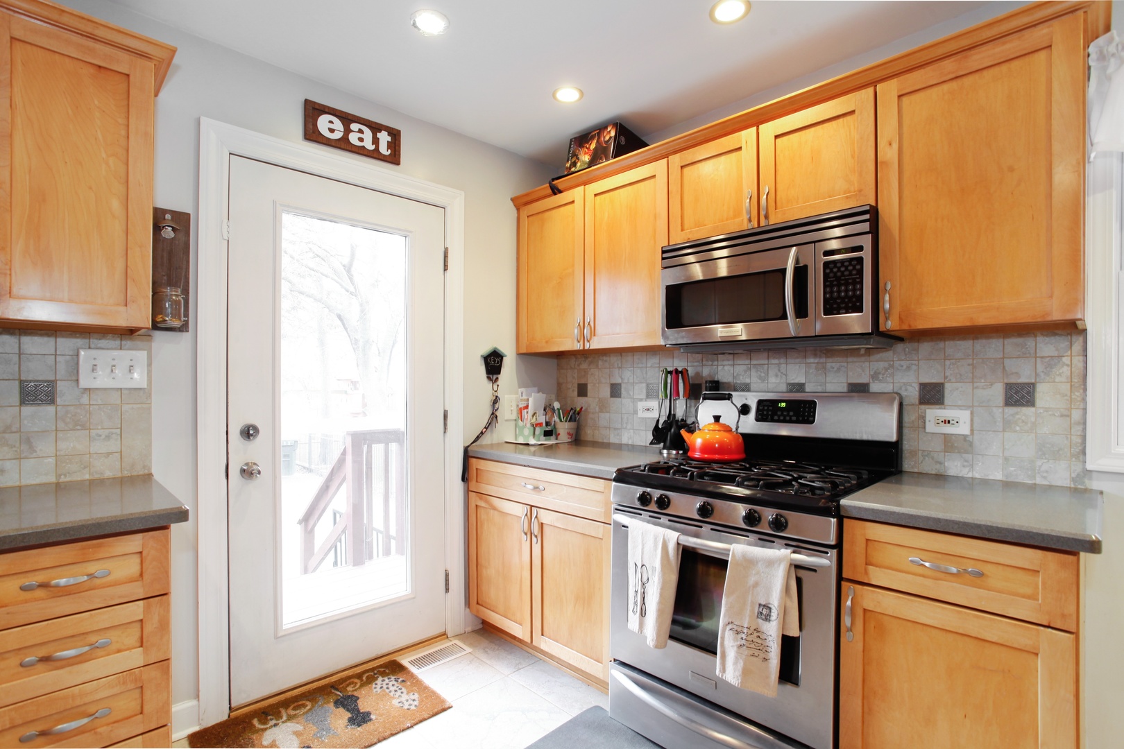137 East Quincy Street Riverside, IL 60546 - Photo 3 of 14 a kitchen with stainless steel appliances granite countertop a stove a microwave and a refrigerator
