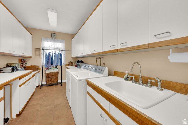 7740 Keswick Road Sandy, UT 84093 - Photo 26 of 74 Utility room featuring a built-in sink with chrome faucet, extensive cabinetry, and a window