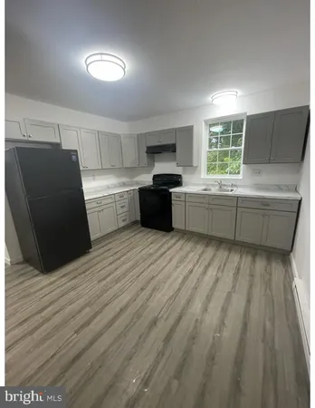 a kitchen with a refrigerator and a sink