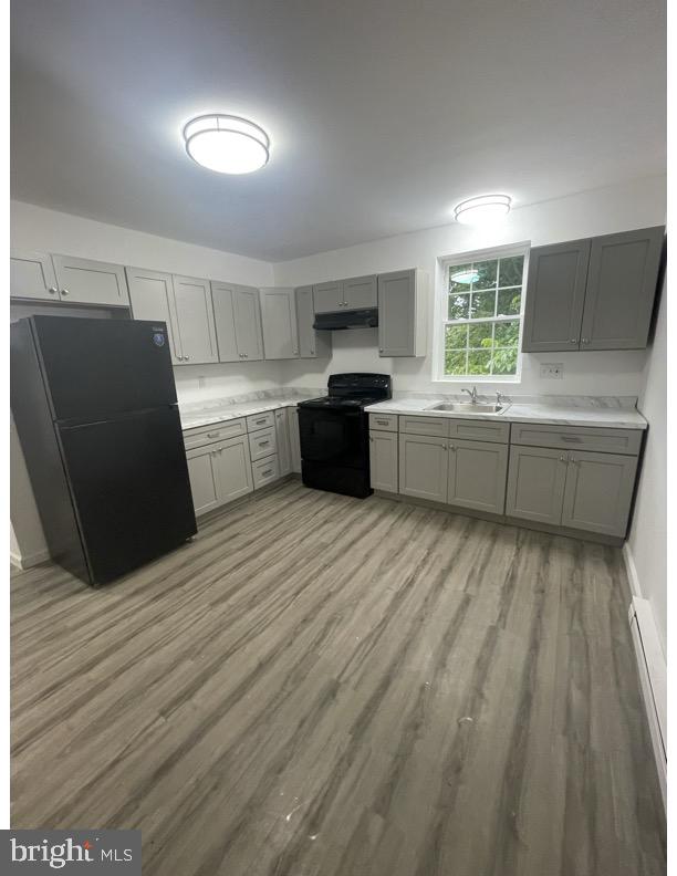 a kitchen with a refrigerator and a sink