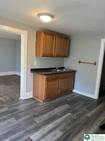 a view of a kitchen with wooden floor