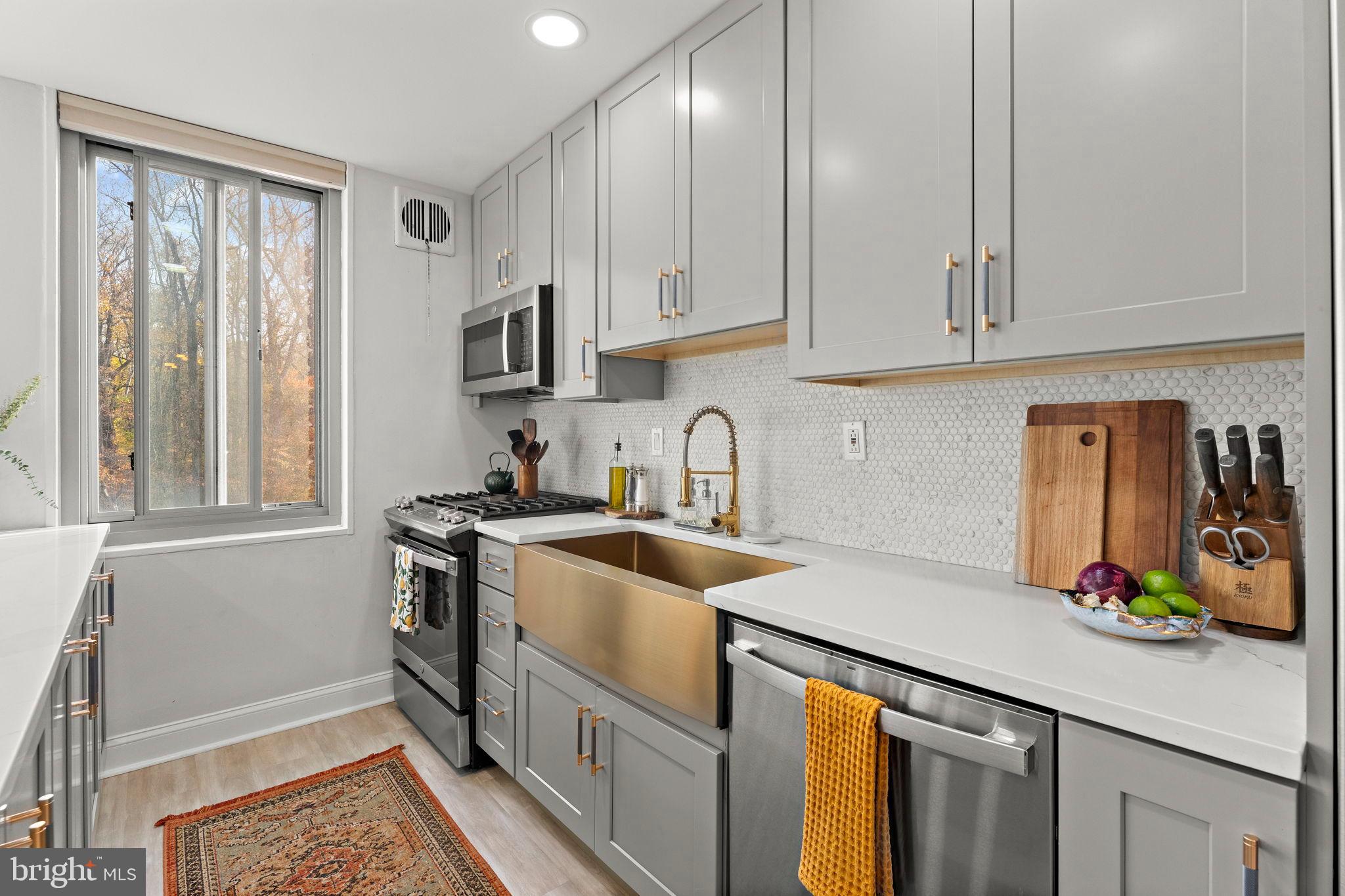 4200 Cathedral Avenue Northwest, Unit 610 Washington, DC 20016 - Photo 11 of 22 a kitchen with stainless steel appliances granite countertop a sink stove and cabinets