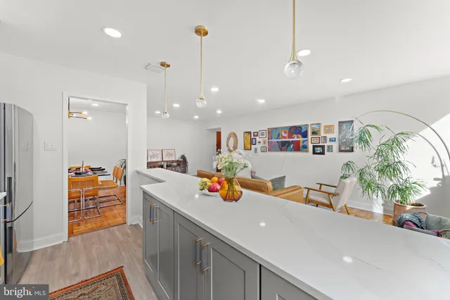a kitchen with stainless steel appliances granite countertop a sink and a refrigerator