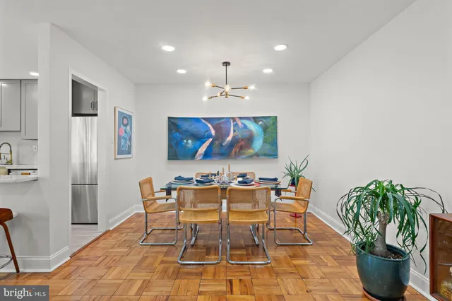 a view of a dining room with furniture and chandelier