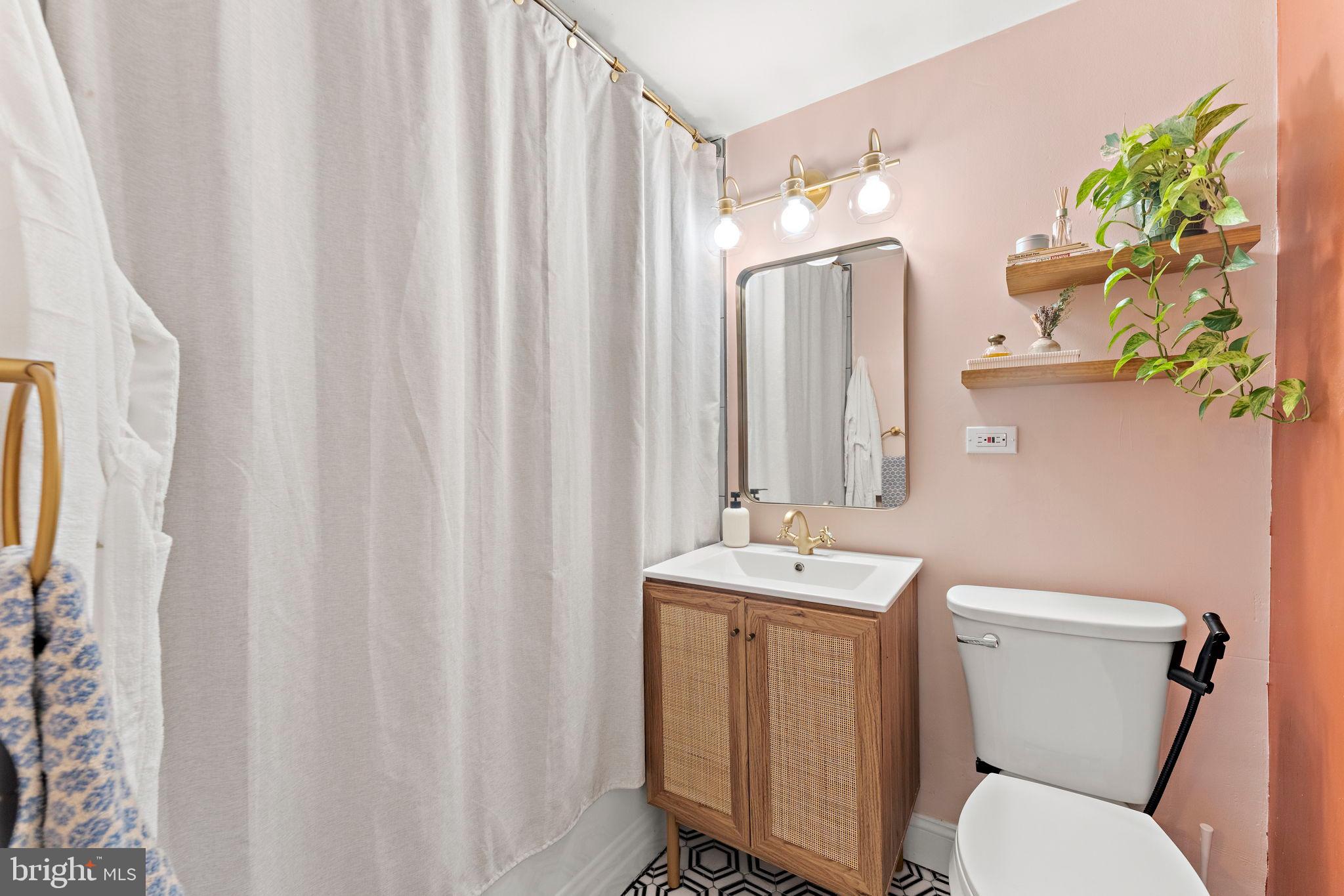 4200 Cathedral Avenue Northwest, Unit 610 Washington, DC 20016 - Photo 16 of 22 a bathroom with a toilet a sink and a mirror