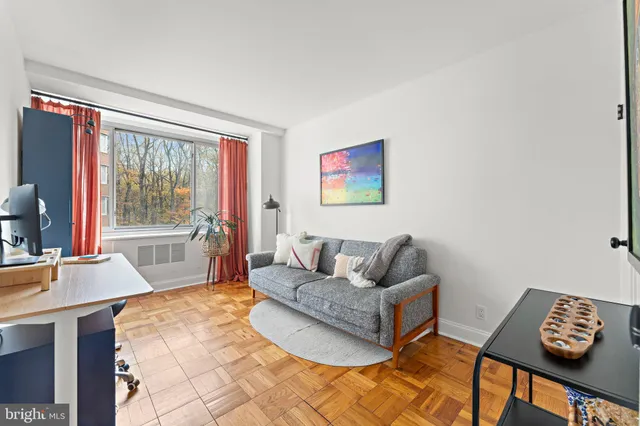 a living room with furniture and a large window