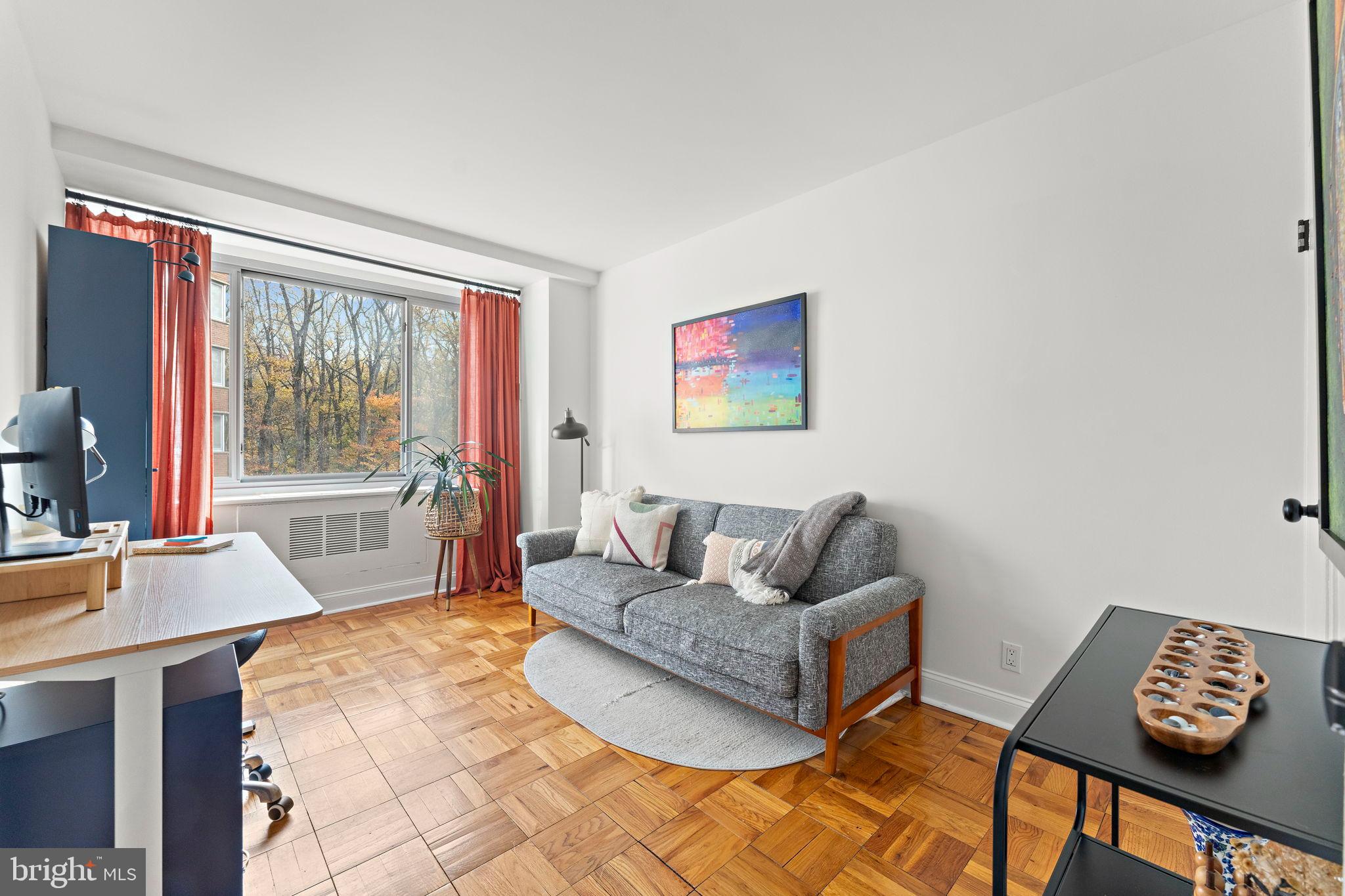 4200 Cathedral Avenue Northwest, Unit 610 Washington, DC 20016 - Photo 18 of 22 a living room with furniture and a large window