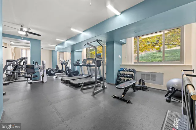 a view of a livingroom with workspace and a window