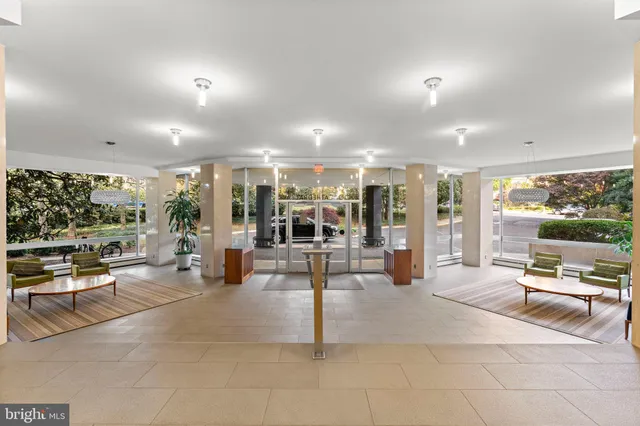 a living room with patio furniture and a large window