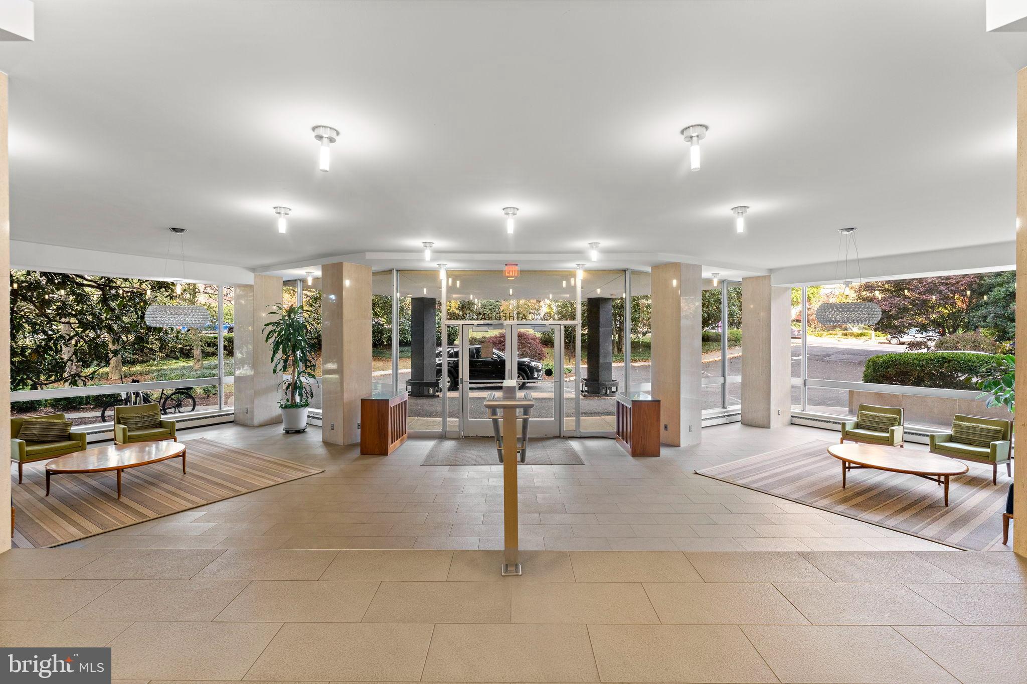 4200 Cathedral Avenue Northwest, Unit 610 Washington, DC 20016 - Photo 3 of 22 a living room with patio furniture and a large window