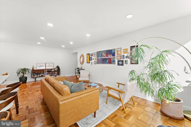 a living room with furniture and a potted plant