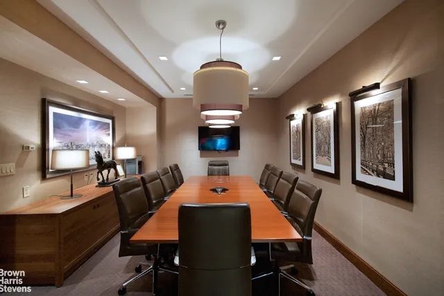 a living room with furniture a chandelier and a flat screen tv