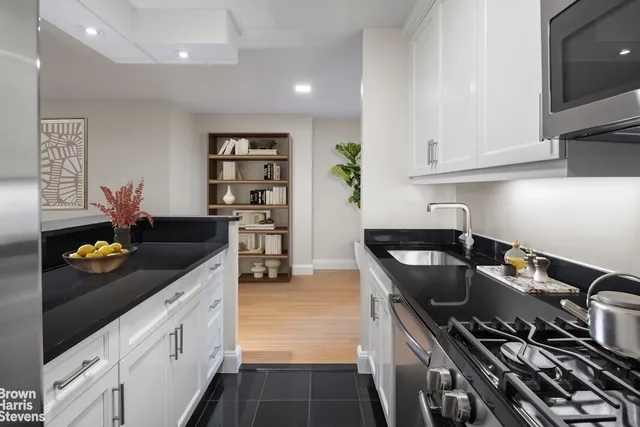 a kitchen with stainless steel appliances granite countertop a stove a refrigerator and a counter space