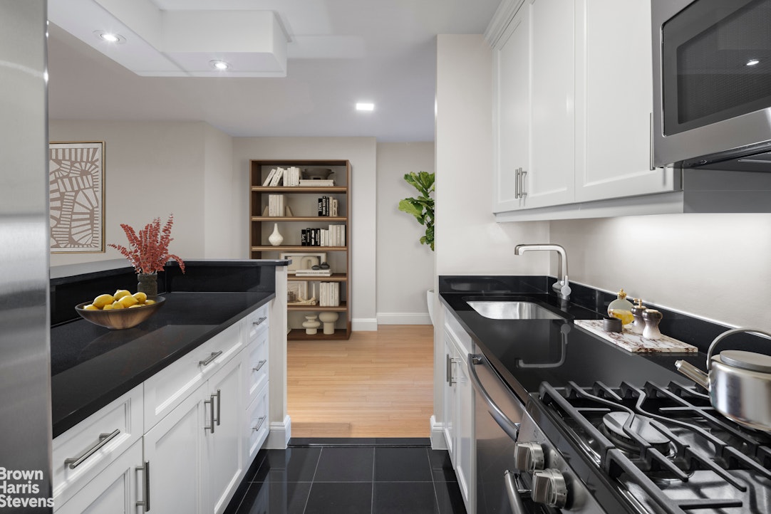155 West 68th Street, Unit 28E Manhattan, NY 10023 - Photo 4 of 19 a kitchen with stainless steel appliances granite countertop a stove and a sink