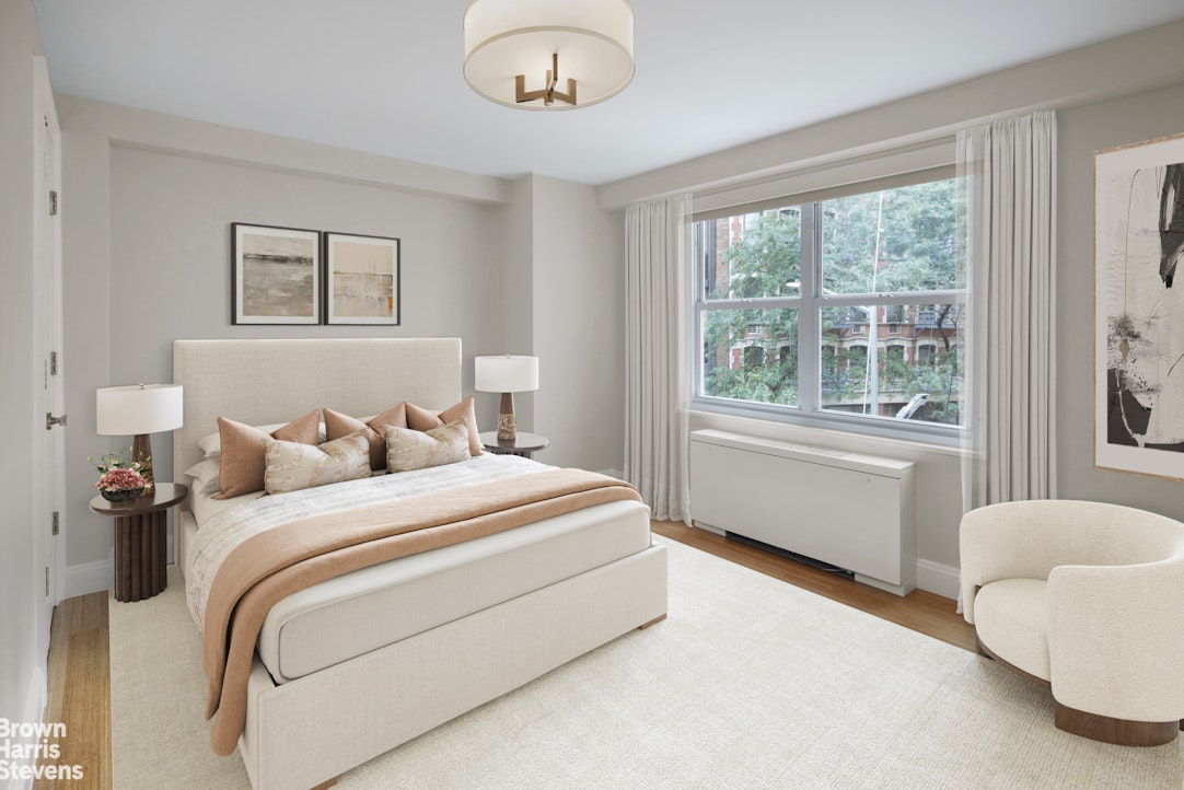 155 West 68th Street, Unit 28E Manhattan, NY 10023 - Photo 9 of 19 a bedroom with a large bed and a large window