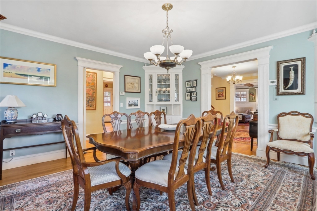 308 Prince Street Newton, MA 02465 - Photo 12 of 40 a view of a dining room with furniture a chandelier and wooden floor