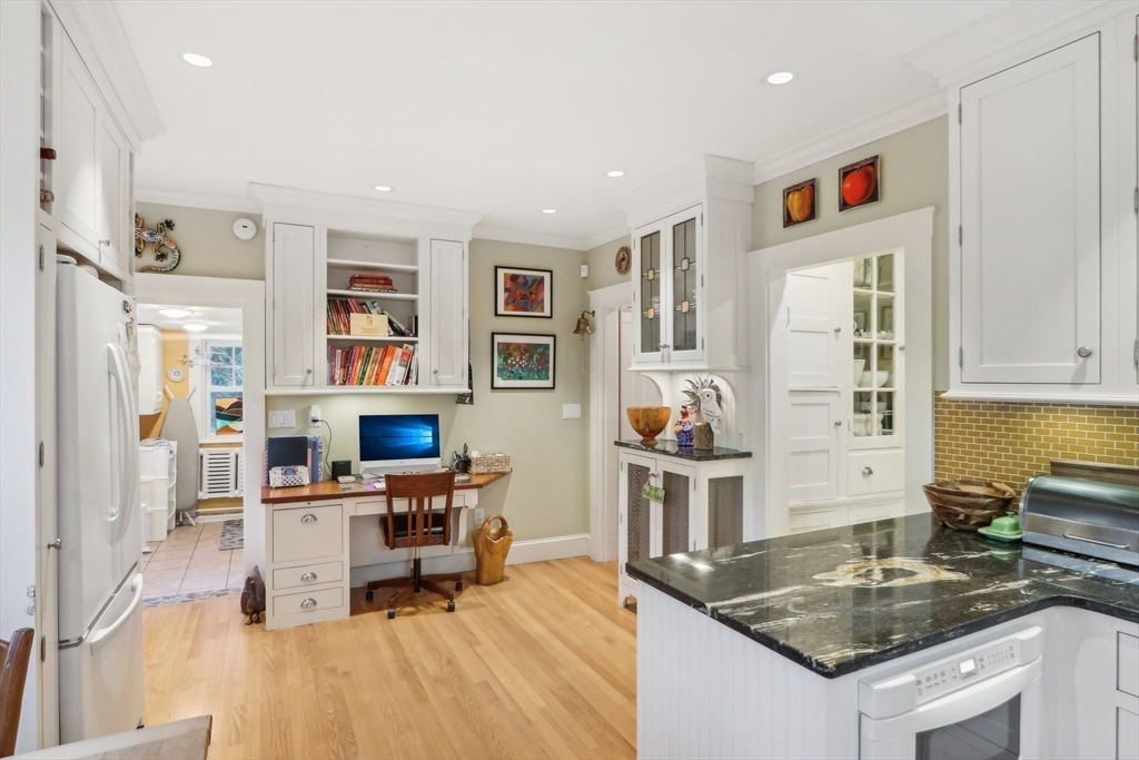 308 Prince Street Newton, MA 02465 - Photo 14 of 40 a kitchen that has a lot of cabinets a sink and appliances in it