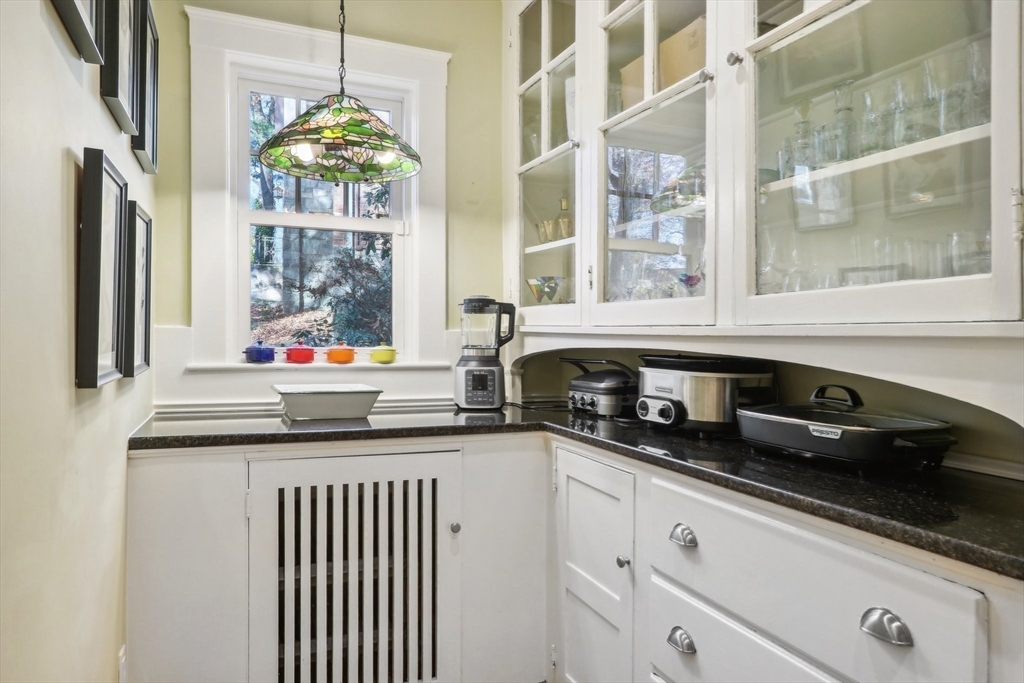 308 Prince Street Newton, MA 02465 - Photo 16 of 40 a kitchen with stainless steel appliances a sink and a window