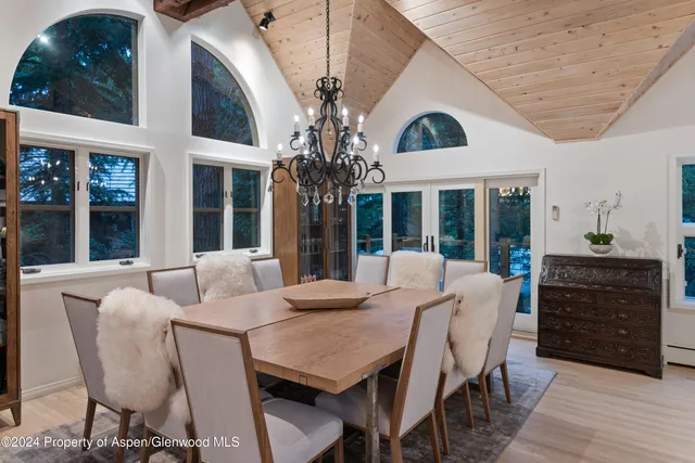 a view of a dining room with furniture wooden floor and chandelier