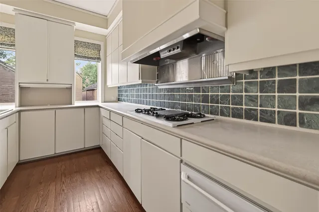 a kitchen with cabinets and window