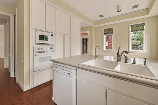a kitchen with sink cabinets and wooden floor